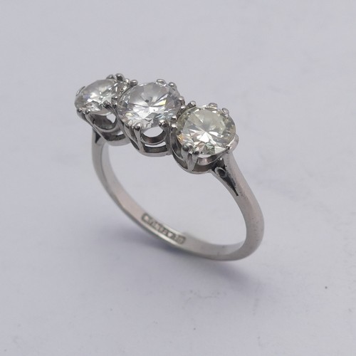 258 - A three stone diamond Ring, the centre stone approx. 0.8ct, with a smaller stone on either side, one... 