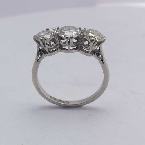 258 - A three stone diamond Ring, the centre stone approx. 0.8ct, with a smaller stone on either side, one... 