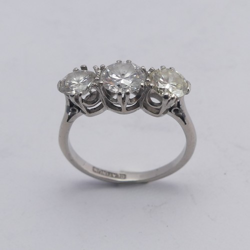 258 - A three stone diamond Ring, the centre stone approx. 0.8ct, with a smaller stone on either side, one... 