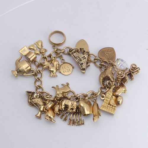 323 - A 9ct yellow gold curb link Bracelet, with 9ct gold padlock clasp, with twenty three charms suspende... 