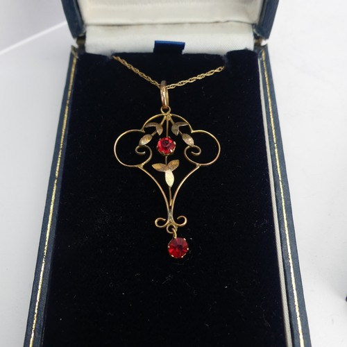 411 - A 9ct gold Art Nouveau Pendant, set two red facetted pastes, 4cm long, on 9ct gold trace chain toget... 