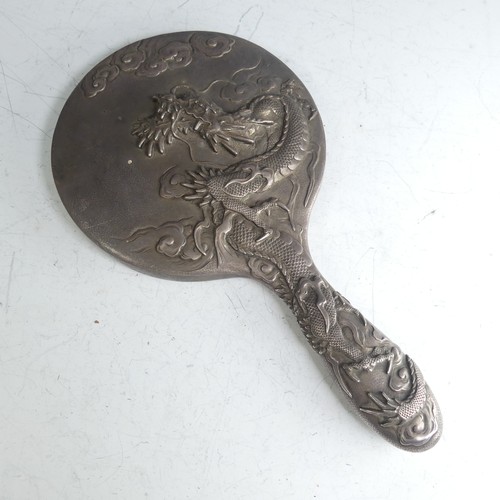 170 - An early 20thC Oriental silver Hand Mirror, with scrolling dragon decoration, character mark on fram... 