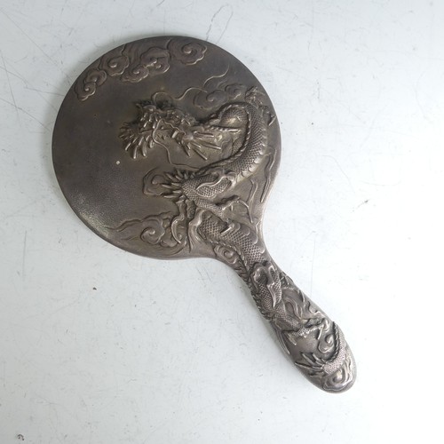 170 - An early 20thC Oriental silver Hand Mirror, with scrolling dragon decoration, character mark on fram... 