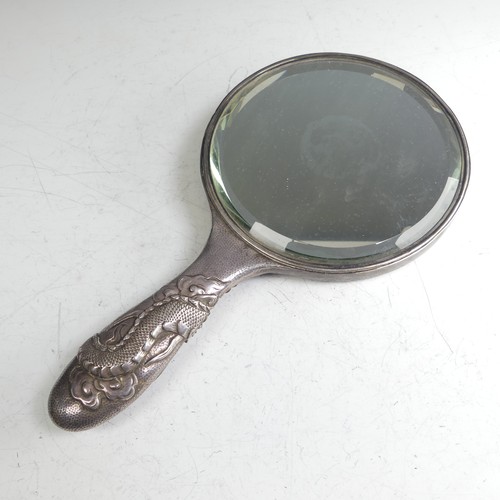 170 - An early 20thC Oriental silver Hand Mirror, with scrolling dragon decoration, character mark on fram... 