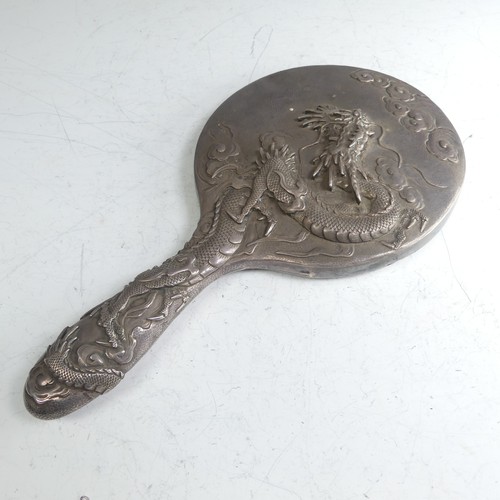 170 - An early 20thC Oriental silver Hand Mirror, with scrolling dragon decoration, character mark on fram... 