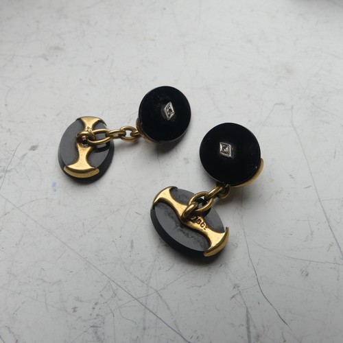 363 - A pair of Art Deco 15ct gold mounted onyx Cufflinks, the oval stones with diamond point centres, tog... 