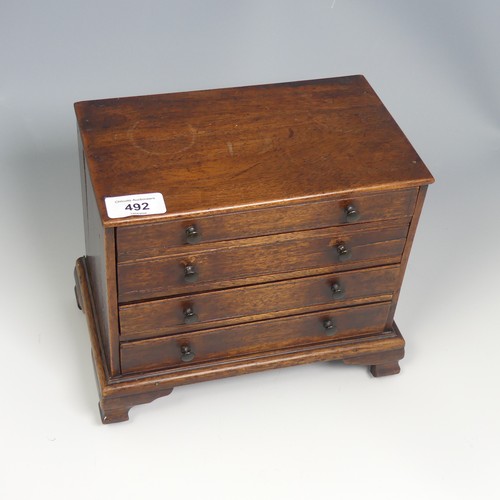 492 - An antique oak miniature tabletop Chest of drawers, rectangular top over four long graduating drawer... 