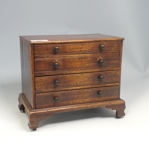 492 - An antique oak miniature tabletop Chest of drawers, rectangular top over four long graduating drawer... 