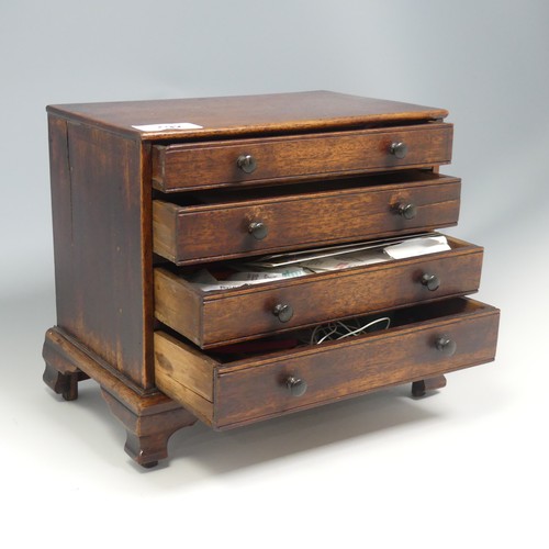 492 - An antique oak miniature tabletop Chest of drawers, rectangular top over four long graduating drawer... 