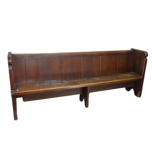 601 - A large antique oak Church Pew, with panelled back and reeded arm supports, W 214 cm x H 84 cm x D 5... 