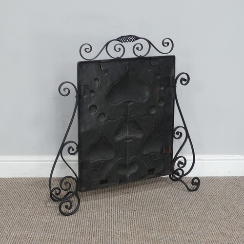 645 - An Art Nouveau copper Firescreen, embossed with stylised hearts and foliage, framed in scrolled wrou... 