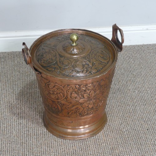 602 - An Arts and Crafts hammered copper Bucket, embossed with Art Nouveau inspired stylised flowers and l... 