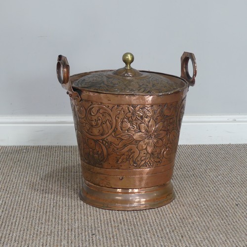 602 - An Arts and Crafts hammered copper Bucket, embossed with Art Nouveau inspired stylised flowers and l... 