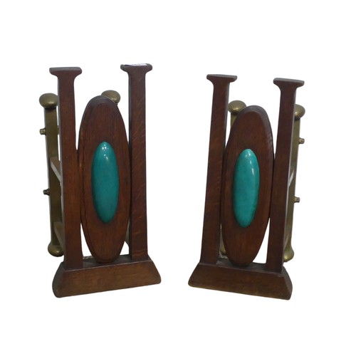 561 - A pair of Arts and Crafts oak and brass Andirons, inset with central cabochons, W 20 cm x H 41 cm x ... 