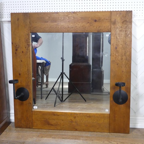 501 - An impressive craftsman-made oak framed Wall Mirror, with iron candle sconces, 122cm x 122cm.... 