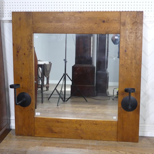 501 - An impressive craftsman-made oak framed Wall Mirror, with iron candle sconces, 122cm x 122cm.... 