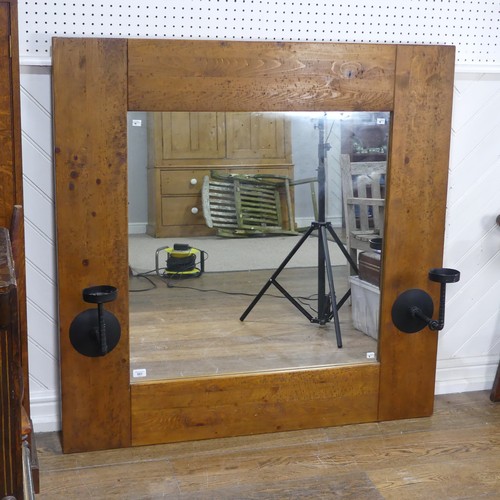 501 - An impressive craftsman-made oak framed Wall Mirror, with iron candle sconces, 122cm x 122cm.... 