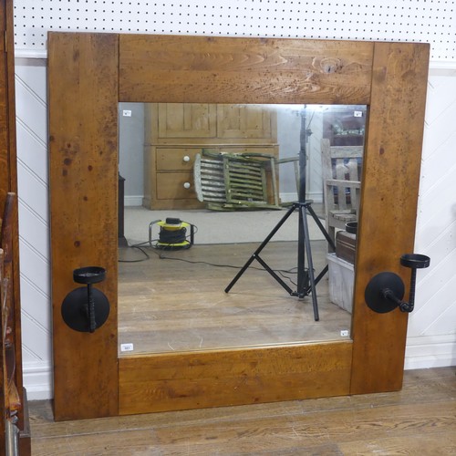 501 - An impressive craftsman-made oak framed Wall Mirror, with iron candle sconces, 122cm x 122cm.... 