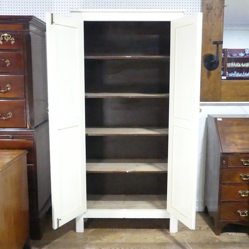 638 - An early 20th century painted pine housekeepers Cupboard, large panelled doors enclosing four deep s... 