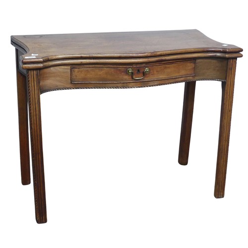 635 - A Georgian mahogany serpentine front folding Tea Table, moulded top raised on square reeded supports... 