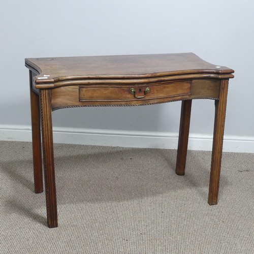 635 - A Georgian mahogany serpentine front folding Tea Table, moulded top raised on square reeded supports... 