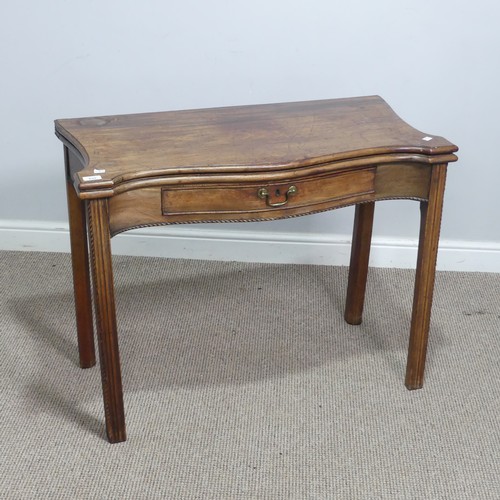 635 - A Georgian mahogany serpentine front folding Tea Table, moulded top raised on square reeded supports... 