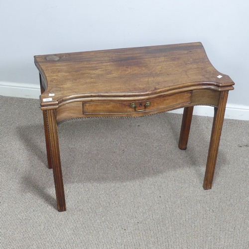 635 - A Georgian mahogany serpentine front folding Tea Table, moulded top raised on square reeded supports... 