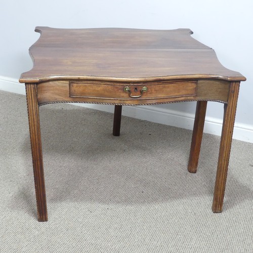 635 - A Georgian mahogany serpentine front folding Tea Table, moulded top raised on square reeded supports... 