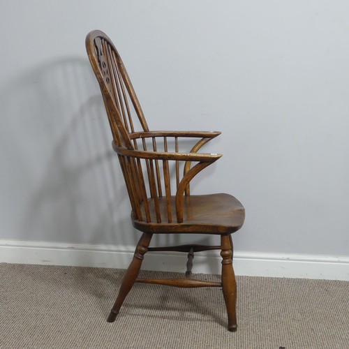 637 - An antique ash and elm windsor Armchair, hoop stick and splat back above squashed pad arms, above sh... 