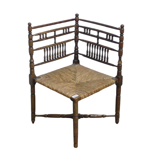 634 - A 19th century sussex-style bobbin turned corner Chair, with rush seat, W 41 cm x H 68 cm x D 42 cm.... 