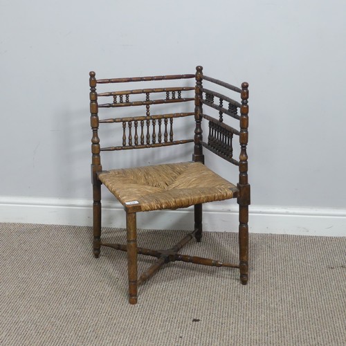 634 - A 19th century sussex-style bobbin turned corner Chair, with rush seat, W 41 cm x H 68 cm x D 42 cm.... 