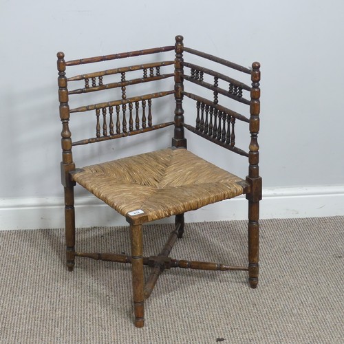 634 - A 19th century sussex-style bobbin turned corner Chair, with rush seat, W 41 cm x H 68 cm x D 42 cm.... 