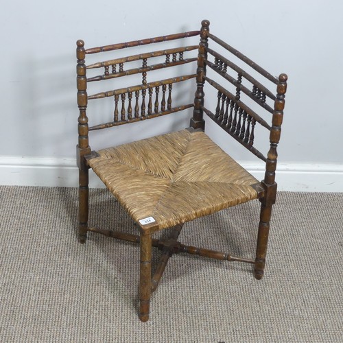 634 - A 19th century sussex-style bobbin turned corner Chair, with rush seat, W 41 cm x H 68 cm x D 42 cm.... 