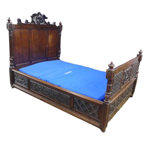 605 - An antique French Breton double Bed, with highly carved headboard and footboard, sideboards with pos... 