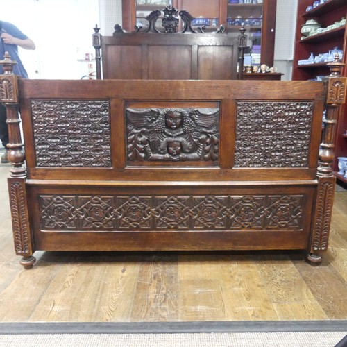 605 - An antique French Breton double Bed, with highly carved headboard and footboard, sideboards with pos... 