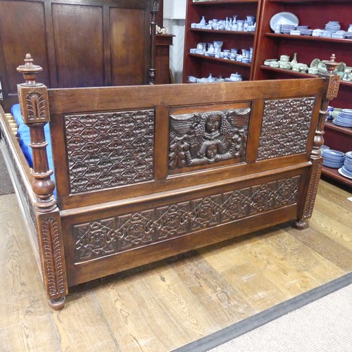 605 - An antique French Breton double Bed, with highly carved headboard and footboard, sideboards with pos... 