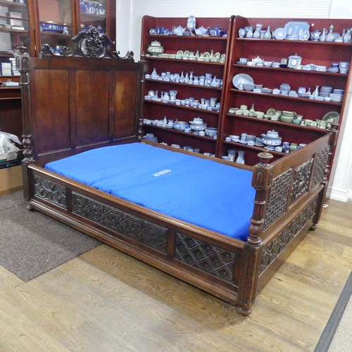 605 - An antique French Breton double Bed, with highly carved headboard and footboard, sideboards with pos... 