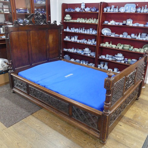 605 - An antique French Breton double Bed, with highly carved headboard and footboard, sideboards with pos... 