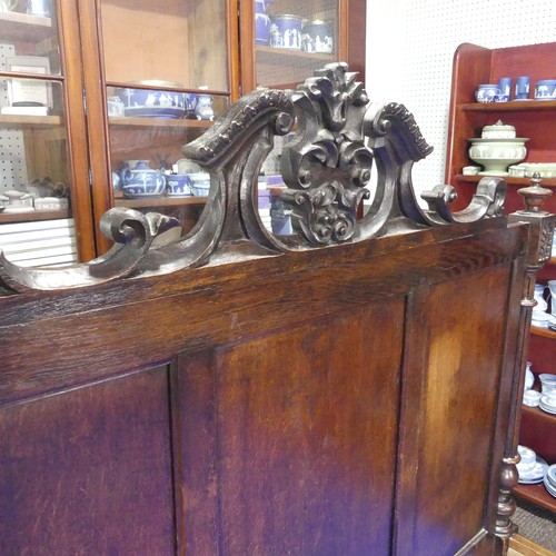 605 - An antique French Breton double Bed, with highly carved headboard and footboard, sideboards with pos... 