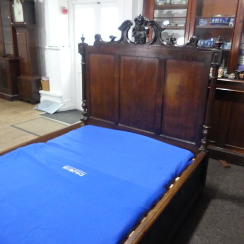 605 - An antique French Breton double Bed, with highly carved headboard and footboard, sideboards with pos... 