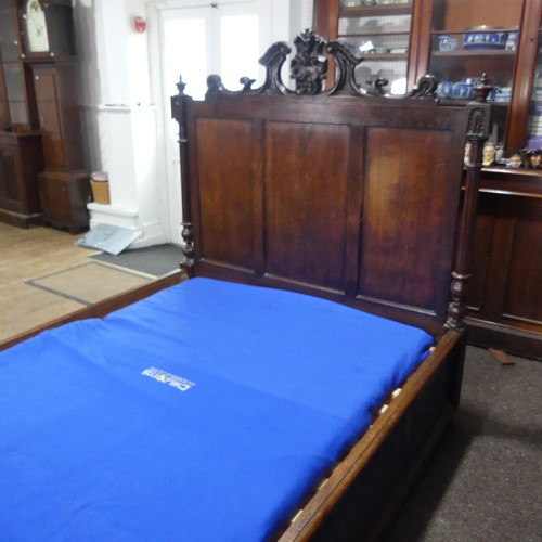 605 - An antique French Breton double Bed, with highly carved headboard and footboard, sideboards with pos... 