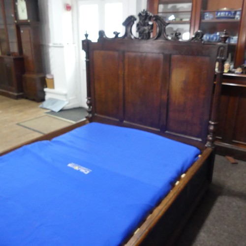 605 - An antique French Breton double Bed, with highly carved headboard and footboard, sideboards with pos... 