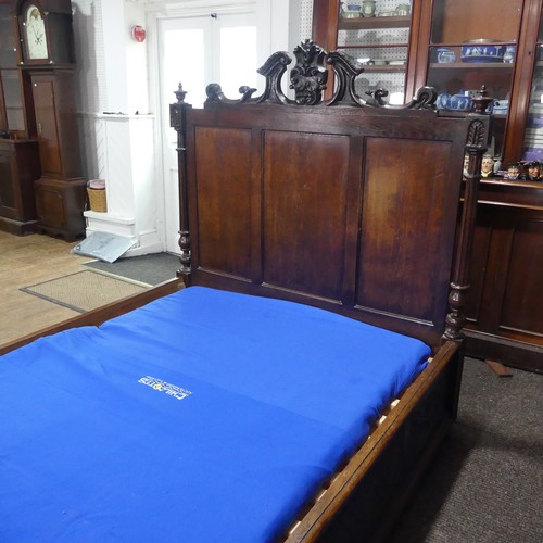 605 - An antique French Breton double Bed, with highly carved headboard and footboard, sideboards with pos... 