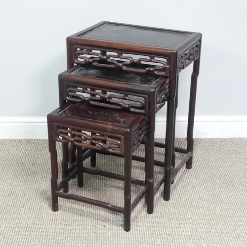 130 - A Chinese nest of three hardwood Tables, probably huanghuali, circa 1900, rectangular tops above mou... 