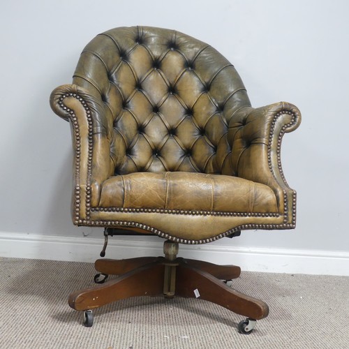 570 - A deep button-back leather swivel desk Chair, scroll arms above serpentine front seat, raised on cas... 