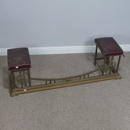 598 - A Victorian brass club Fender, with two flanking rectangular original leather seats, supported by br... 