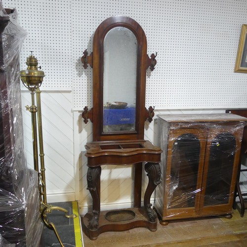 562 - A Victorian mahogany serpentine front Hall Stand, of narrow proportions, arched mirror flanked by tw... 