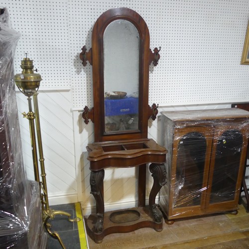 562 - A Victorian mahogany serpentine front Hall Stand, of narrow proportions, arched mirror flanked by tw... 