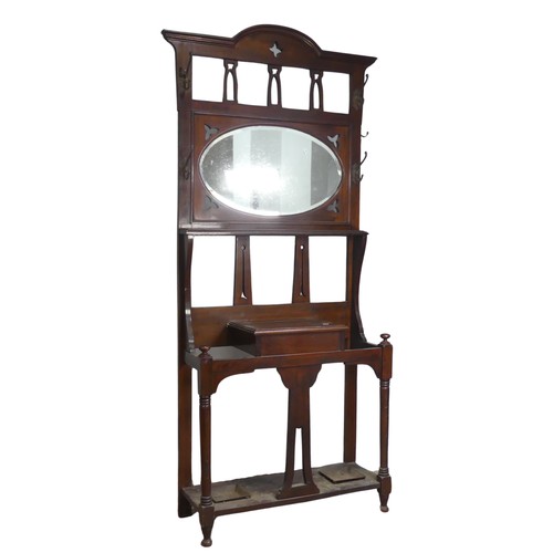 597 - A Victorian mahogany Hall Stand, with pierced Gothic style apertures above oval bevelled mirror and ... 