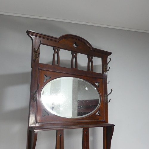 597 - A Victorian mahogany Hall Stand, with pierced Gothic style apertures above oval bevelled mirror and ... 